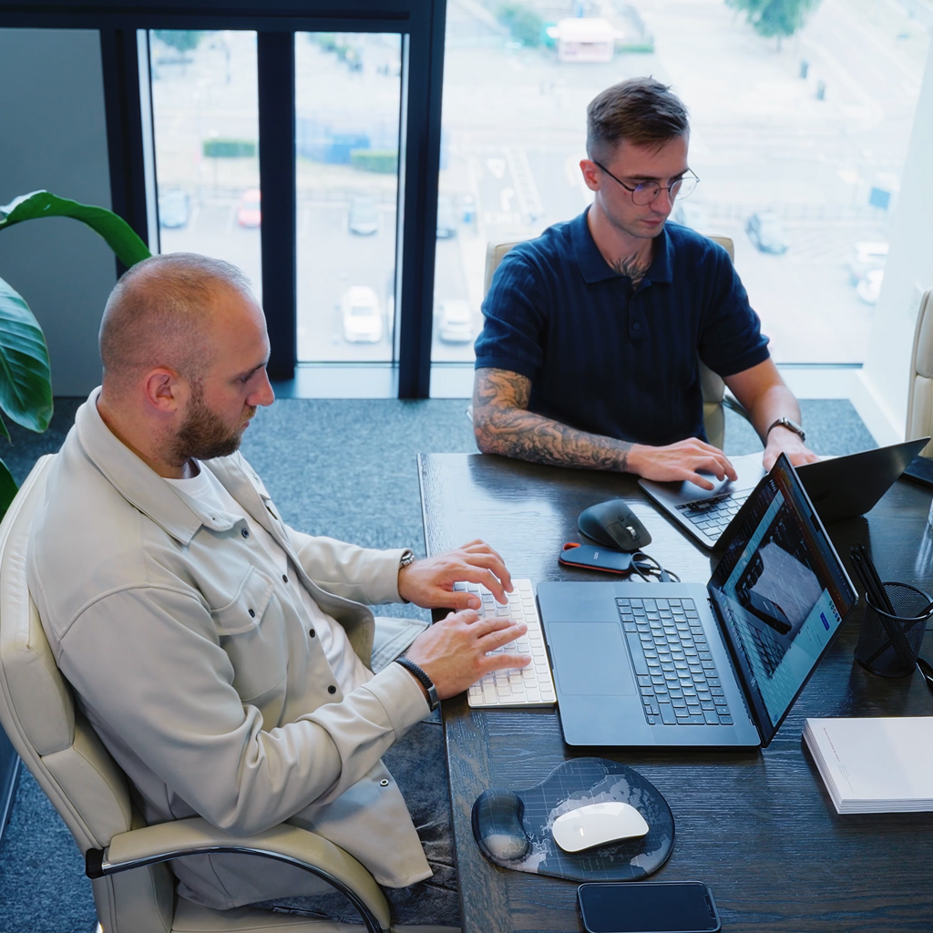 a vibrant meeting room filled with a diverse group of local web developers engaged in lively discussion, surrounded by inspiring design sketches and digital screens showcasing innovative projects, illuminated by warm, natural light streaming through large windows.